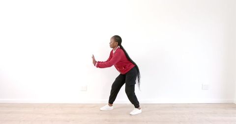 Woman Practicing Dance Moves in Bright Minimalist Room