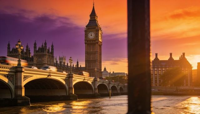 Big ben and westminster bridge glowing in golden sunset over thames with warm reflections