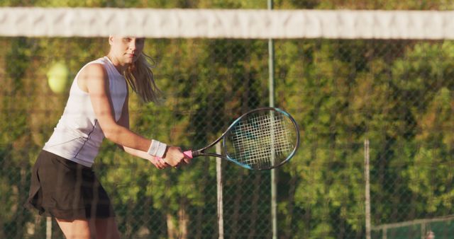 Female Tennis Player Ready to Hit Ball with Racket Outdoors - Download Free Stock Images Pikwizard.com