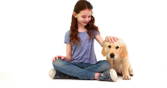 Young girl with long brown hair petting a golden retriever puppy while sitting on a white background. Ideal for use in advertisements about pet care products, children's products, or promotions emphasizing animal companionship and family. Suitable for articles or blogs on raising children with pets, emotional benefits of pets, and pet's import8 to mental health. The image conveys a sense of comfort, joy, and bonding between child and animal.