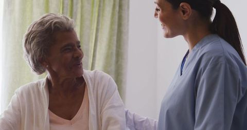 Nurse Assisting Senior Woman in Retirement Home
