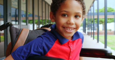 Smiling African American Boy in Wheelchair at School Corridor - Download Free Stock Images Pikwizard.com