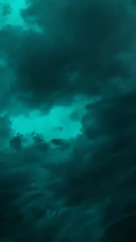 Teal Clouds Drifting and Parting Revealing Light, Aerial Vertical Video Loop