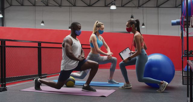 Personal Trainer Instructing Diverse Clients in Gym with Masks - Download Free Stock Images Pikwizard.com