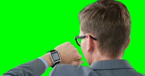 Businessman Analyzing Smartwatch Against Green Screen - Download Free Stock Images Pikwizard.com