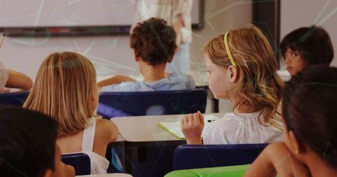 Group of children in classroom talking and sharing ideas, with digital interface illustrating concept of technology integration in education.