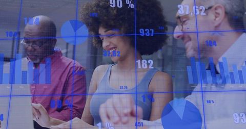 Smiling diverse team collaborating over interactive data dashboards analyzing insights