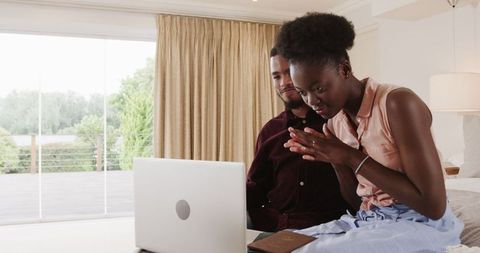 Young couple enjoying digital content together at home