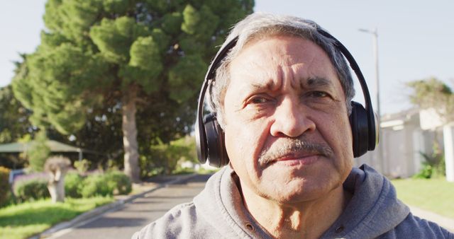 Senior Man Outdoors Wearing Headphones Listening to Music - Download Free Stock Images Pikwizard.com