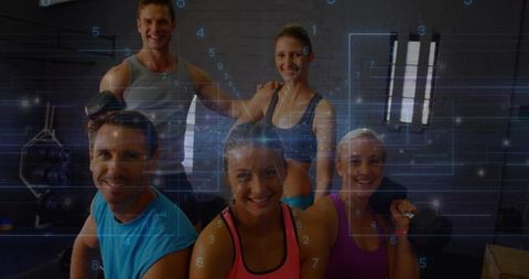 Group fitness team training with blue digital hud overlay for smart gym concept