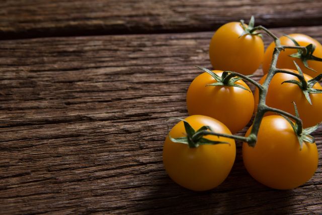 Close-up of yellow tomatoes on wooden table