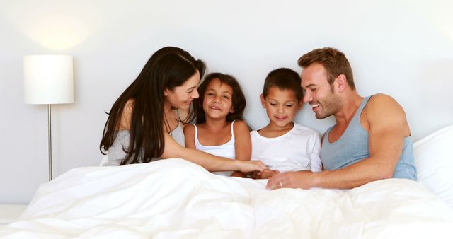 Happy Family Relaxing in Bed Together in the Morning - Download Free Stock Images Pikwizard.com