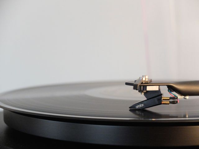 Closeup of Turntable Playing Vinyl Record with Ortofon Cartridge - Download Free Stock Photos Pikwizard.com