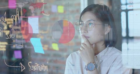 woman analyzing layered financial charts and data, useful for illustrating concepts in global finance and digital data technology. suitable for reports on financial strategy and data visualization techniques.