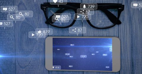 Social media engagement concept with smartphone and glasses