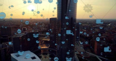 Futuristic urban skyline with digital commerce icons at sunset