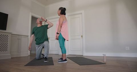 Senior Couple Staying Active with Home Exercises on Yoga Mats