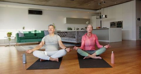 Senior Couple Meditating Peacefully in Modern Home Living Area