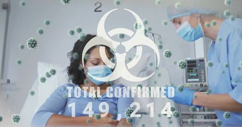 Masked patient receiving iv infusion while nurse monitoring pump amid viral biohazard