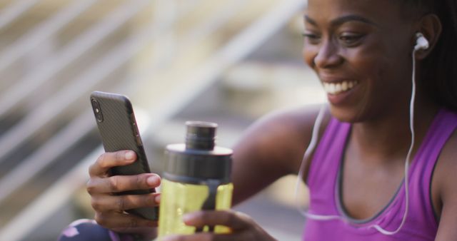 Smiling Woman Wearing Earphones Enjoying Phone Call During Outdoor Workout - Download Free Stock Images Pikwizard.com