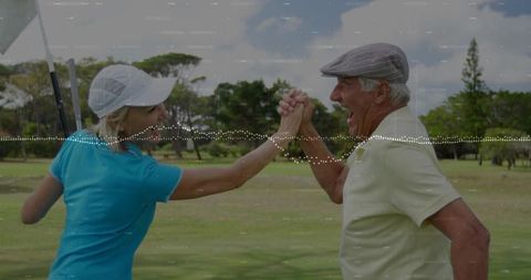 Joyful Senior Golfers Celebrating Success with High Five on Fairway