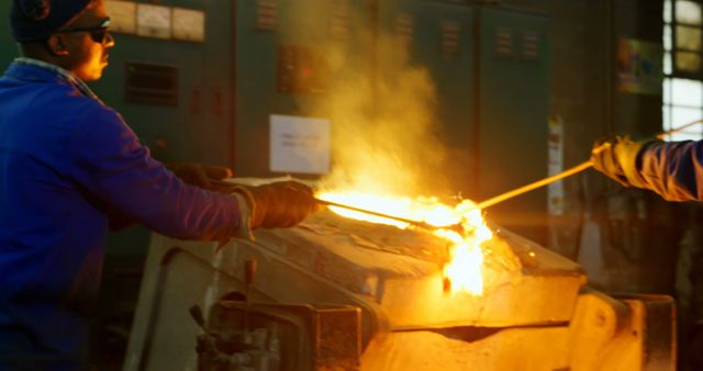 Workers Managing Molten Metal in Industrial Foundry - Download Free Stock Images Pikwizard.com