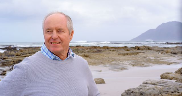 Senior Man Smiling on Rocky Beach - Download Free Stock Images Pikwizard.com