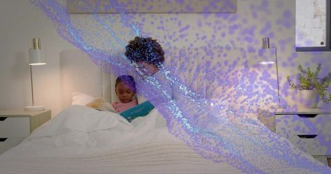 Mother reading bedtime story to daughter in cozy bedroom with plush toy