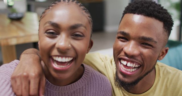 Happy african american couple talking to camera during image call. Lifestyle, relationship, spending free time together concept.