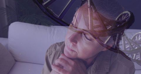 Mature woman contemplating genetics, dna helix double exposure, reflective senior portrait