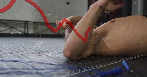 Exhausted athlete lying on gym floor with fitness data overlay and falling graph