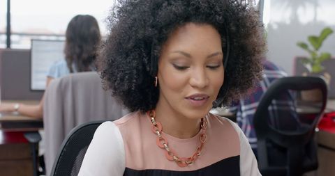 African American Woman Using Headset in Office Environment