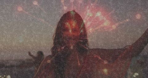 Silhouette of Woman Celebrating by Lake with Vibrant Fireworks