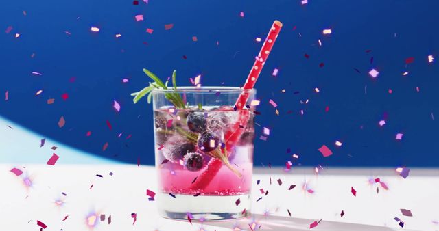 Festive Cocktail with Confetti and Berries on Blue Background - Download Free Stock Images Pikwizard.com