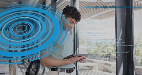 Young professional using tablet with augmented reality interface and code overlay