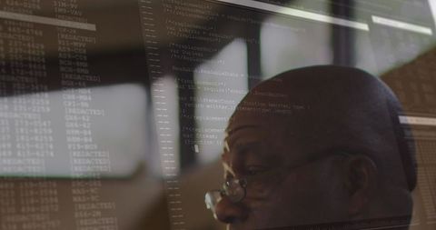 Coding overlay on thoughtful businessman's reflection in office