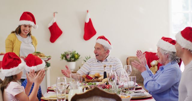 Family Celebrating Christmas Dinner with Festive Hats and Stockings - Download Free Stock Images Pikwizard.com