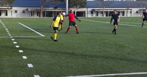 Soccer players engaged in intense field competition