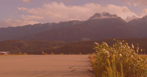 Peaceful Airstrip Adjacent to Majestic Mountain Range - Download Free Stock Images Pikwizard.com