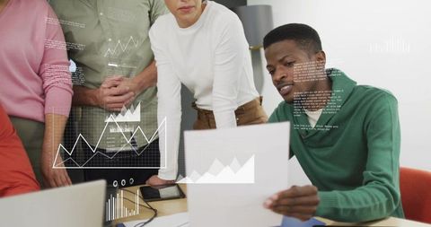 Team Analyzing Data Reports with Interactive Charts and Laptop in Modern Office Meeting