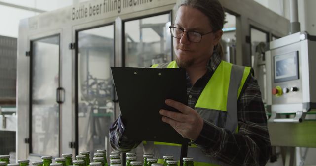 Quality Control Expert Inspecting Bottled Beverages in Factory - Download Free Stock Images Pikwizard.com