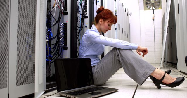 Stressed IT Professional in Data Center with Laptop - Download Free Stock Images Pikwizard.com