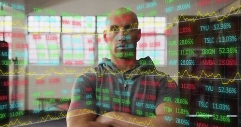 Analyzing financial markets through transparent dashboard overlay with focused trader and charts