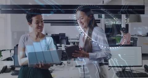 Women Discussing Innovation and Digital Technology in Modern Office