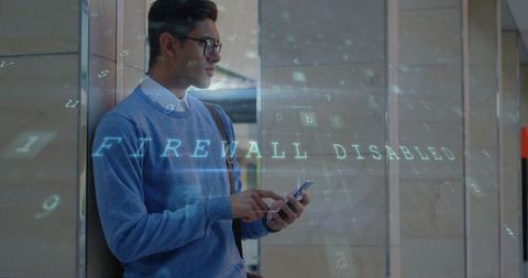 Man Using Smartphone with Digital 'Firewall Disabled' Interface