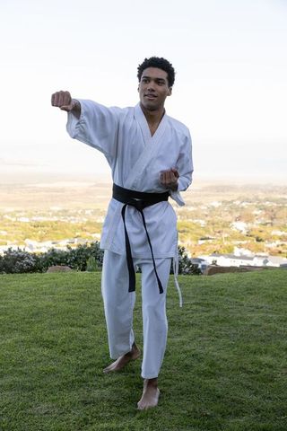 Karate training outdoors on scenic hillside