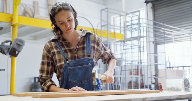 Focused Female Woodworker Using Mallet in Workshop - Download Free Stock Images Pikwizard.com