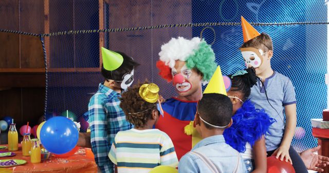 A clown entertains a diverse group of children at a birthday party, with copy space. Balloons, party hats, and colorful decorations set a festive mood for the celebration.