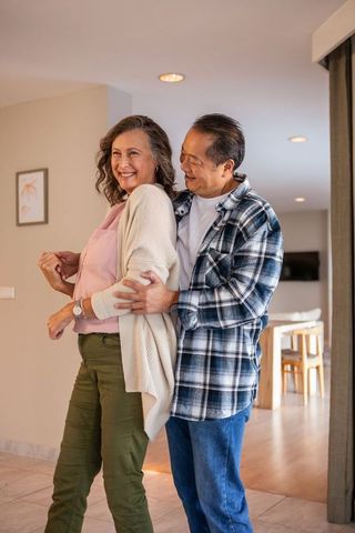 Senior Couple Embracing in Modern Home Living Area