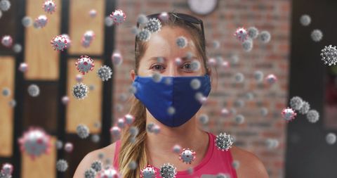 Woman in Gym with Mask Among Floating COVID-19 Icons - Download Free Stock Images Pikwizard.com